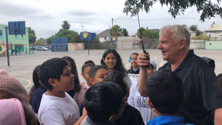 Darrell Warren practicing how to loudly and clearly speak into a radio