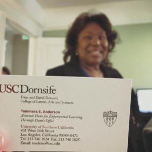 A picture of Tammy (blurred) with her new business card held in front of her