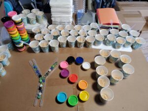 A picture of different stem supplies like cups and play dough forming the letters YSP