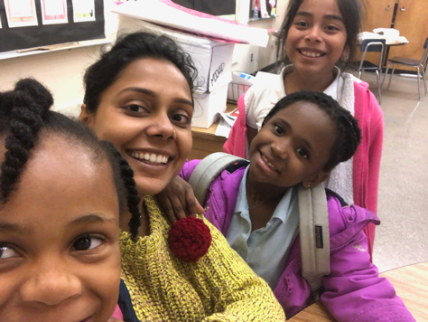 STEM TA Anupam posing for a picture with grade school kids