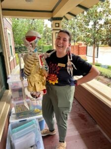 Graduate Student Maya posing with Skeleton
