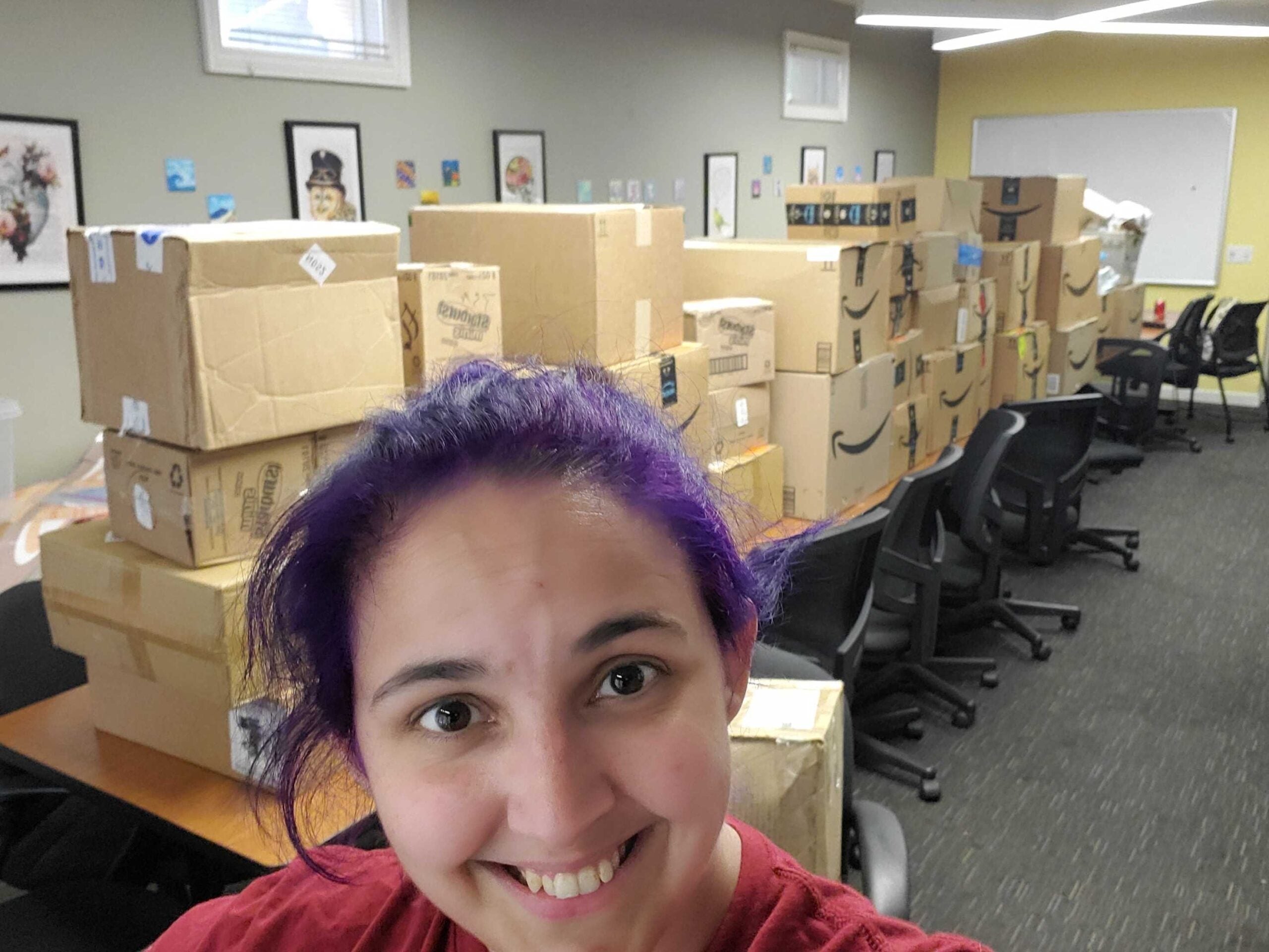 Jess standing in front of over 15 big boxes