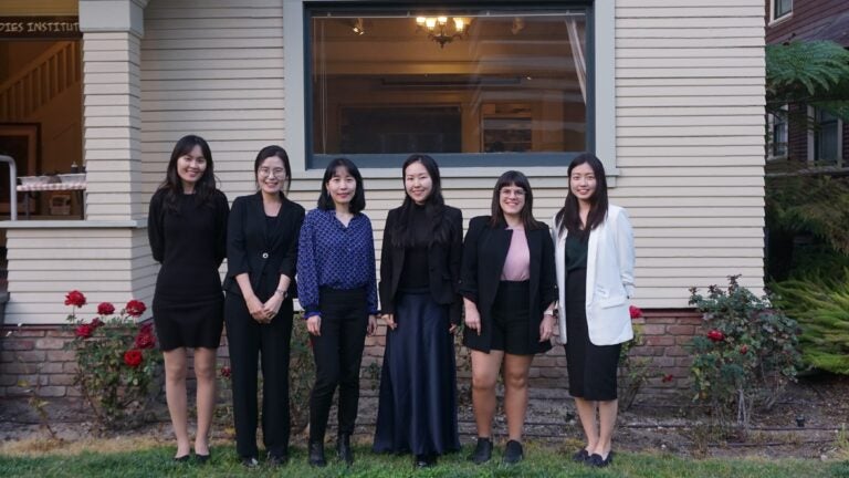 Participants in the Annual USC KSI Graduate Symposium stand in front of the Ahn House