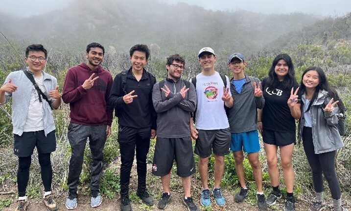 Students posing on top of a mountain