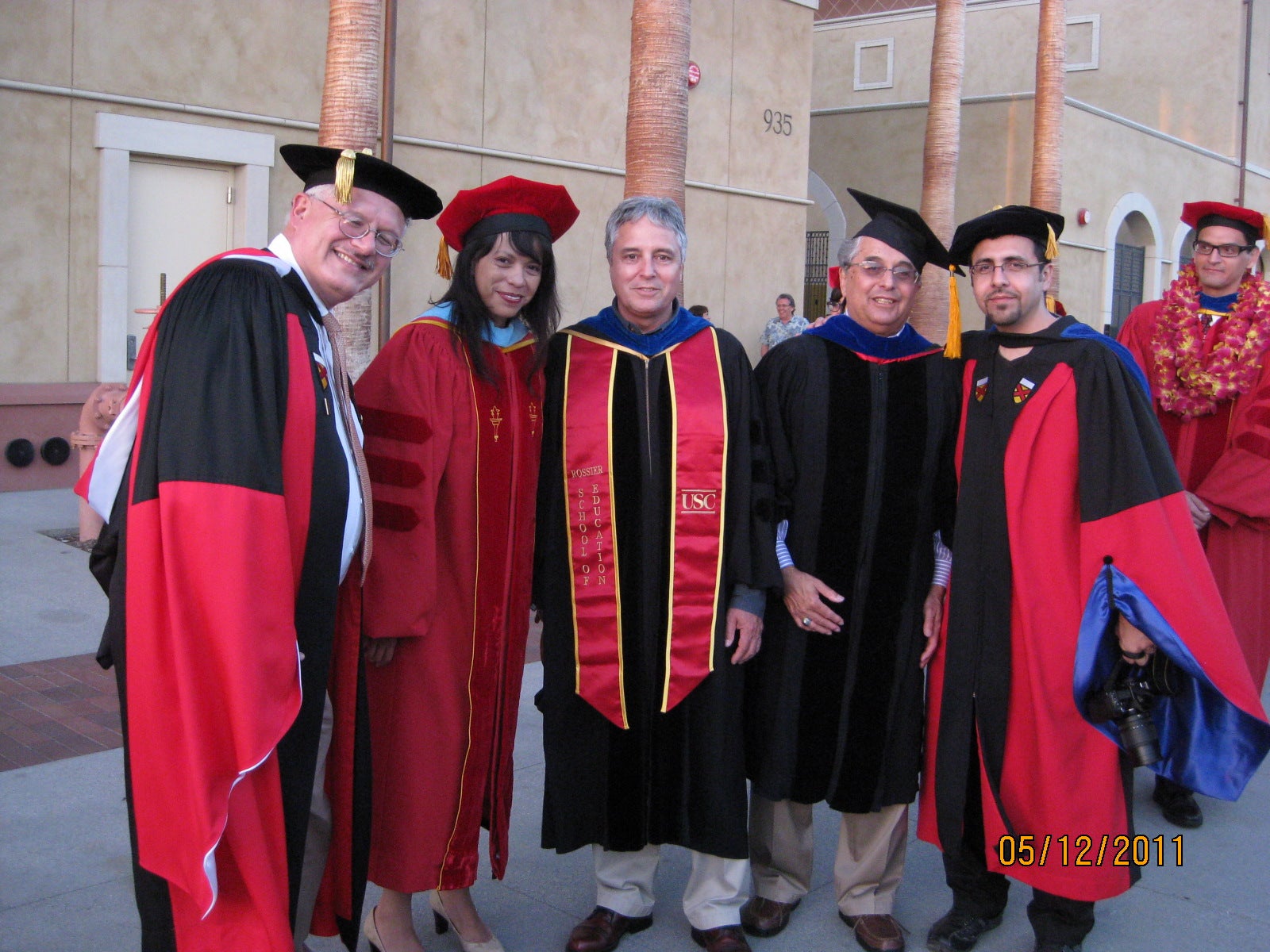 A group of Latino Forum members wearing caps and gowns at commencement.