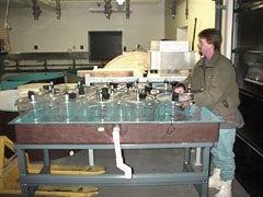 Man investigating samples at aquarium of McMurdo Station, Antarctica.