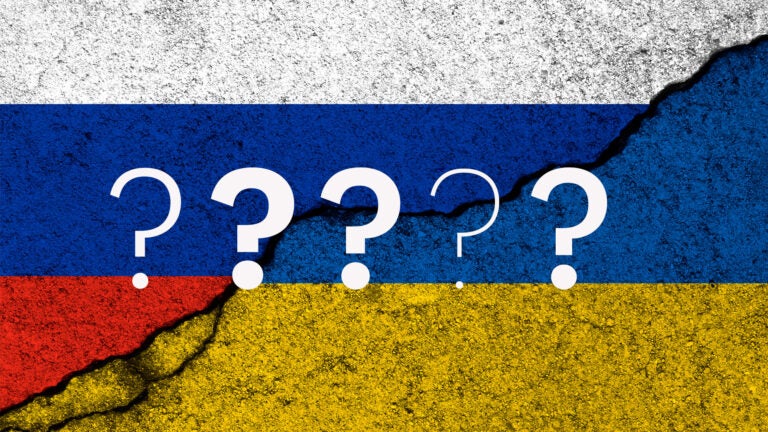 Composite shows question marks floating over a fractured, half-Russia half-Ukraine flag