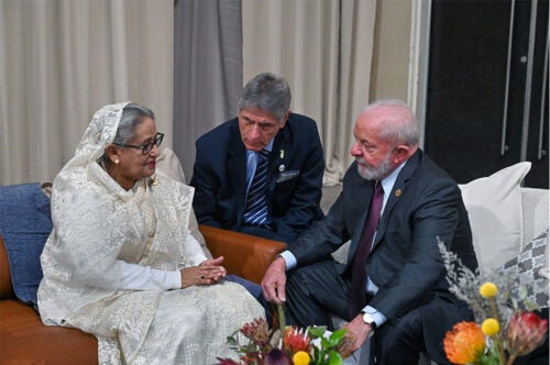 Brazilian President Luiz Inácio Lula da Silva pictured seated talking to 