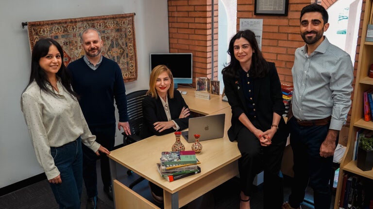 Institute of Armenian Studies staff gathered around a desk