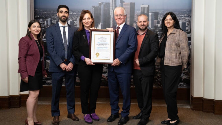 L.A. City Council President Emeritus Paul Krekorian holds a placard with Institute of Armenian Studies staff
