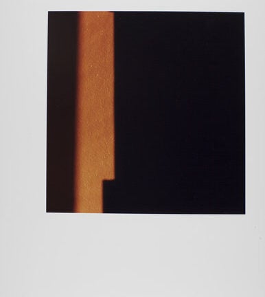 Photo of light on black square. Square is placed against a white background.