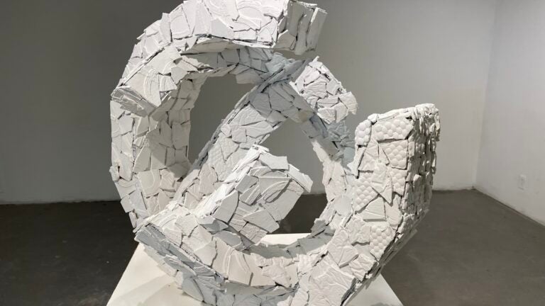 White plaster and cardboard sculpture viewed from an angle.