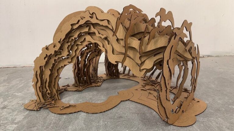 Cardboard sculpture; abstract design of electricity, water, and storm elements.