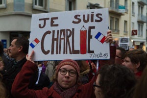 Protester at street demonstration holding a  "Je suis Charlie" sign