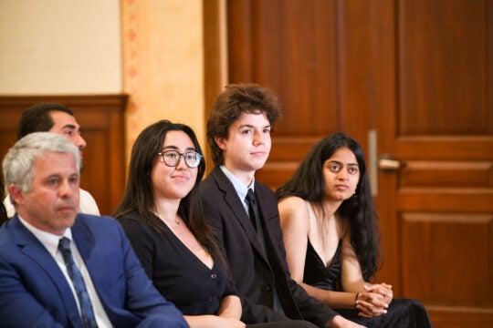 Member of PBK Executive Board, Robin Romans, sitting with the three undergraduate award recipients.