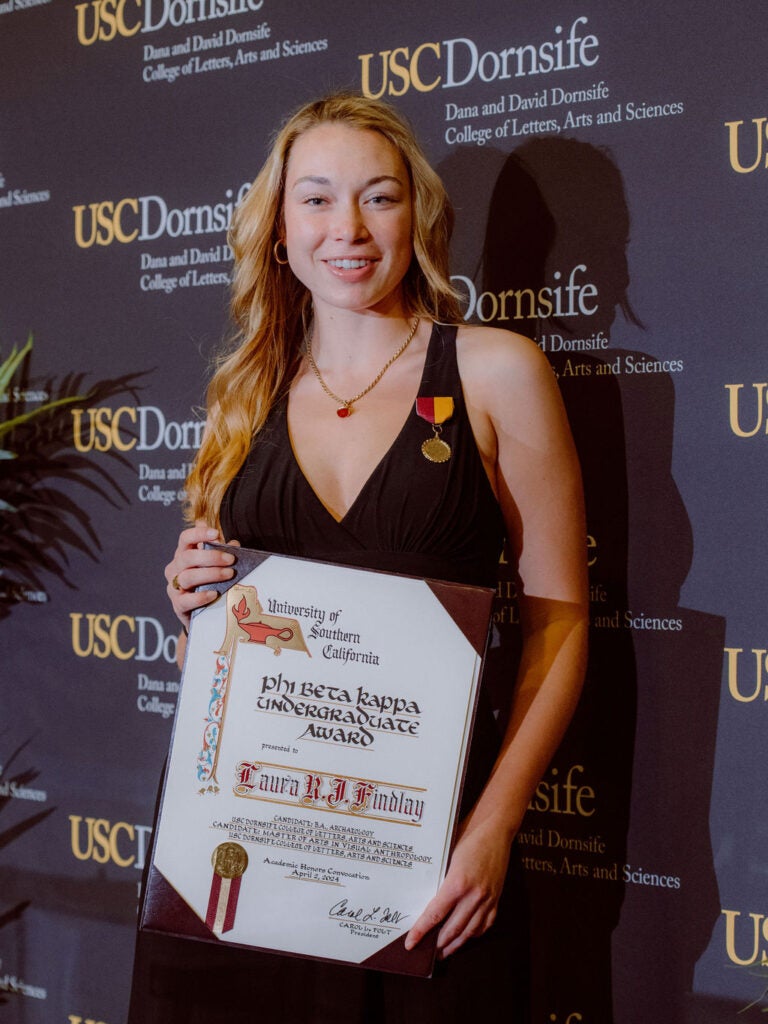 2024 Undergraduate Award Recipient, Laura Findlay, holding award certificate.