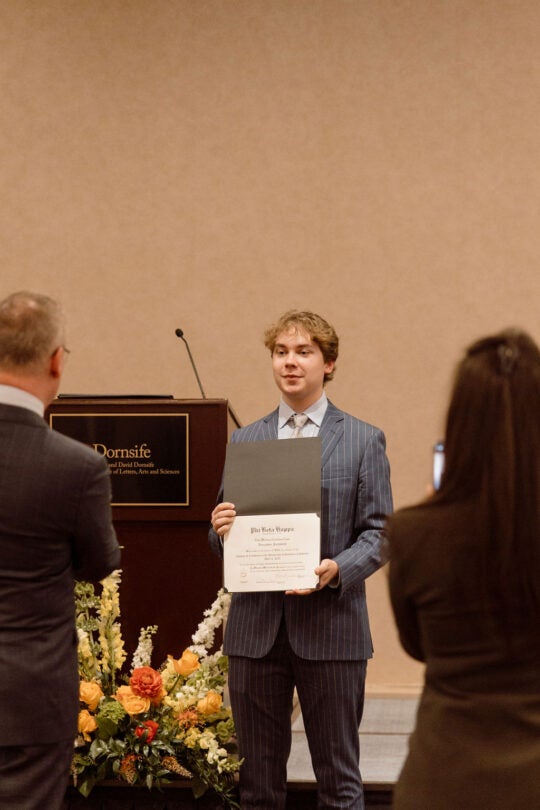 Inductee holding certificate.