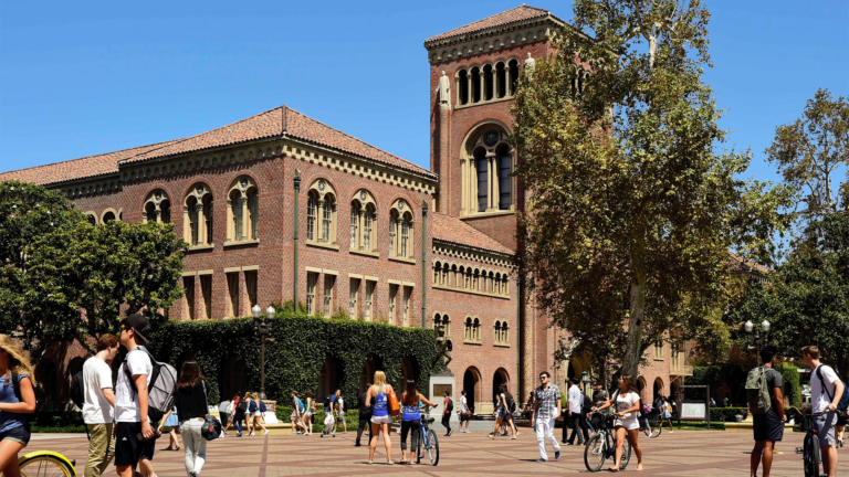 Picture of Bovard Auditorium with students walking by.
