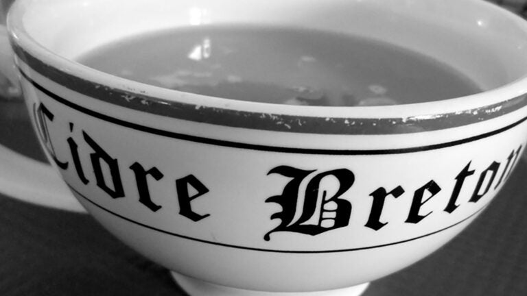 Black and white photo of a tea cup with the words Cidre Breton.