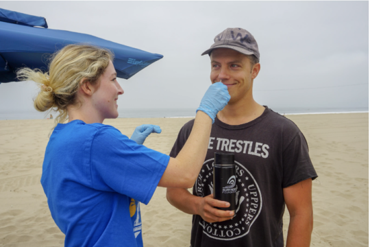 USC Sea Grant Funded Researcher Jay swabbing the nose of a surfer to test for antibiotic resistant bacteria