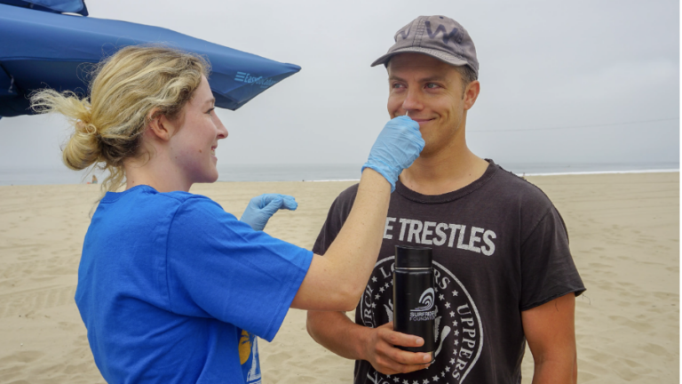 USC Sea Grant Funded Researcher Jay swabbing the nose of a surfer to test for antibiotic resistant bacteria