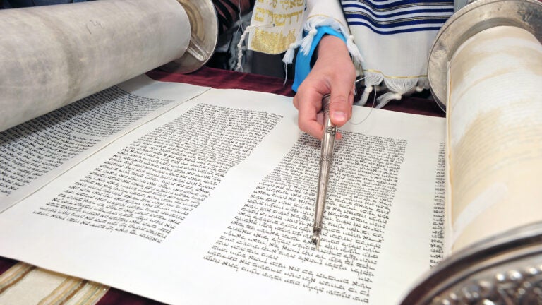 Person pointing at Torah