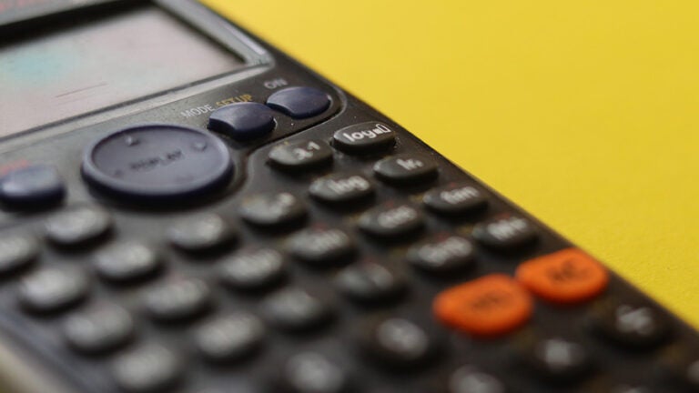 close up of a calculator on yellow background