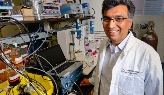 Sri Narayan, professor of chemistry at USC Dornsife, works with a liquid-based redox-flow battery in his lab
