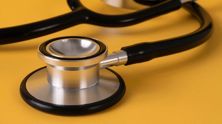 image of stethoscope on yellow gold background