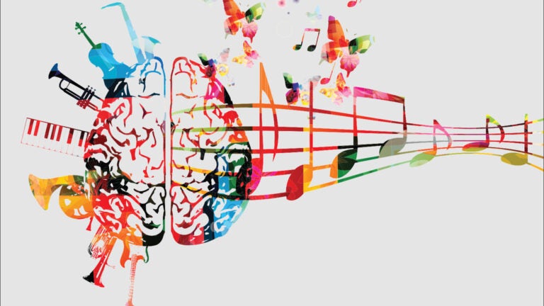 Artistic rendering of the human brain with musical notes and instruments in a rainbow of colors.