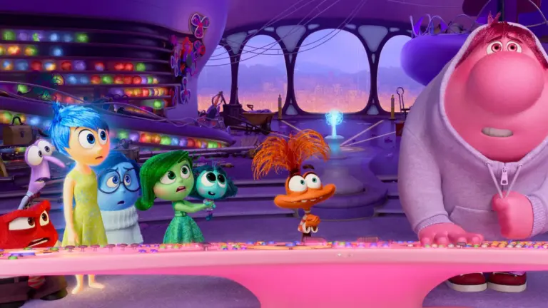A still from Disney's Inside Out featuring several colorful animated characters representing various internal emotions at a pink command center console