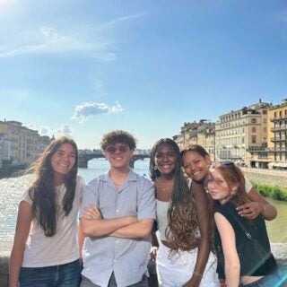 Group of students pose on bridge in Rome
