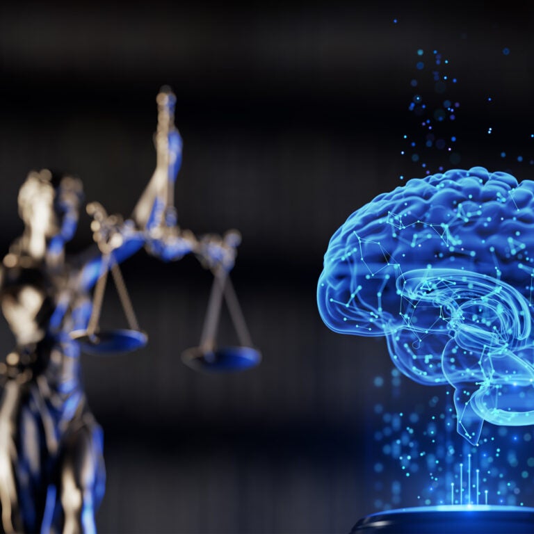 justice statue with a blue virtual rendering of a brain in front of it