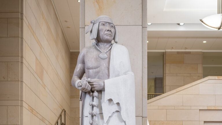 Statue of Po'pay in a marble-walled alcove