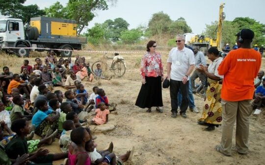 Dave and Dana Dornsife spend time with children in the African village where their philanthropy provides clean water