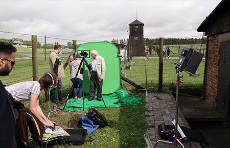 Photo of Pinchas Gutter preparing to film at Majdanek.