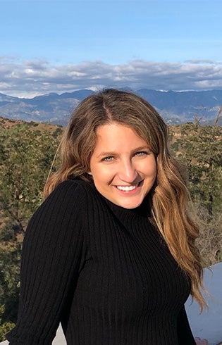 Alexa Weintraub smiles at camera. She is wearing a black shirt.