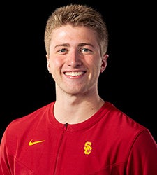 Paul Retterer smiles while wearing a red USC jersey.