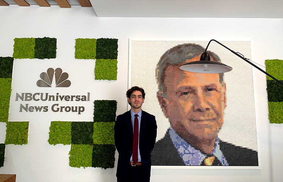 Photo of Austin Peay in front of NBCUniversal News Group sign