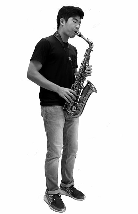 Black-and-white cut-out photo of Simon Wang wearing casual clothes playing saxophone against a white background.