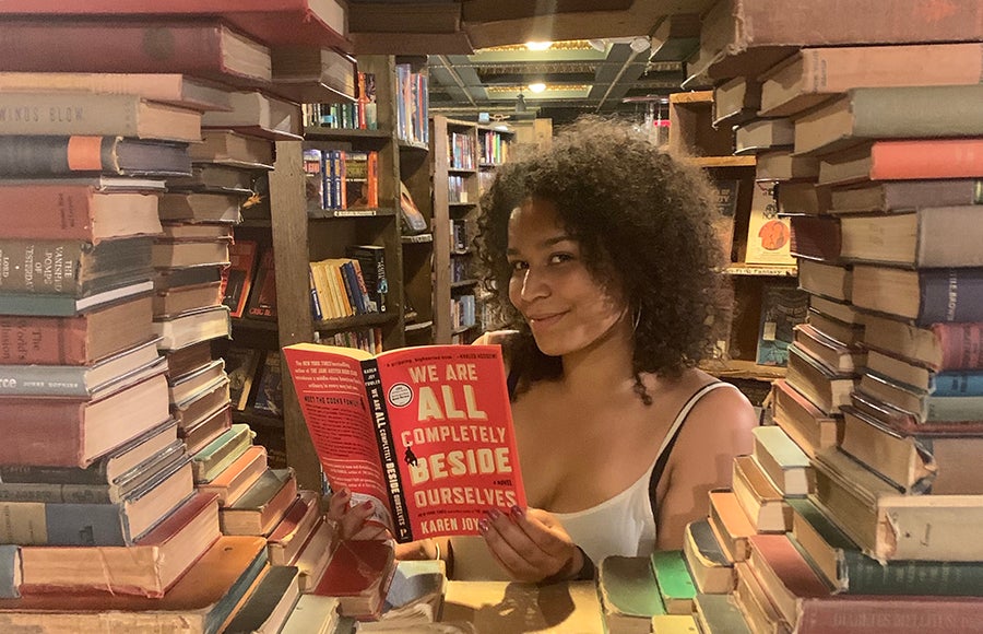 Photo of India Sposato holding a book in The Last Bookstore