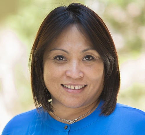 Portrait of Rhacel Salazar Parrenas smiling wearing a blue top