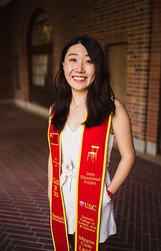 A photo of Tianyu Wang wearing a graduation stole.