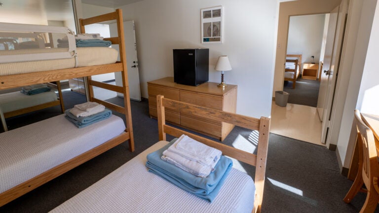 a WMSC dorm room with bunkbeds and a bathroom shared with an adjoining room