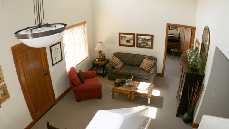 overhead view of a living room with sofas and coffee table