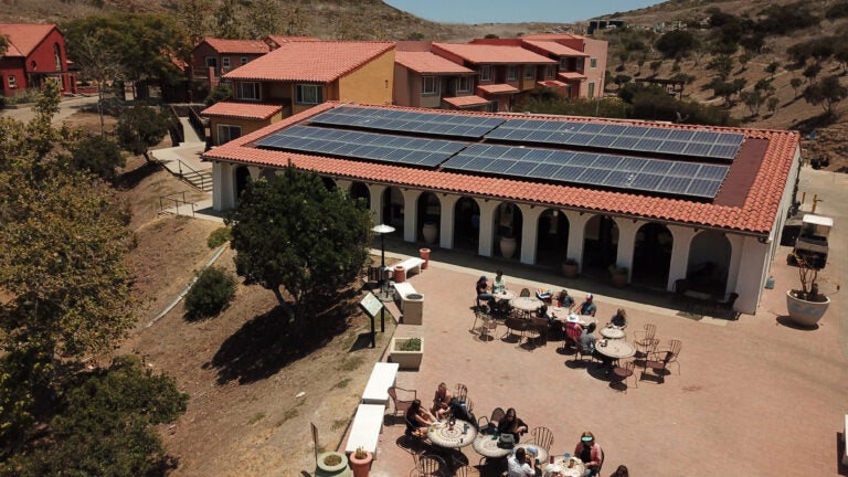 the WMSC dining hall, a one-story white stucco building with an adjacent patio and solar panels on the roof