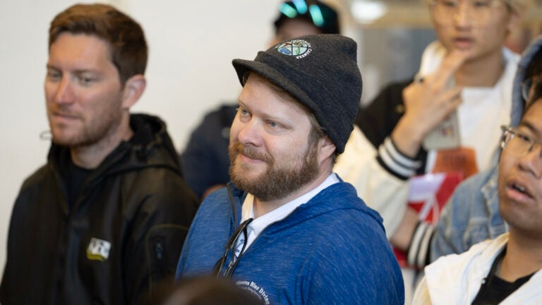 A group of people attentively listen to someone