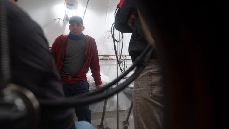 A person leans on a bed in the catalina hyperbaric chamber